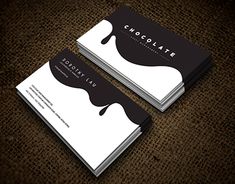 two business cards with chocolate on them sitting next to each other in front of a brown background