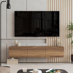 a large flat screen tv mounted to the side of a wooden cabinet in a living room