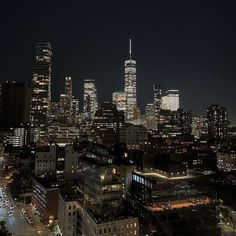 the city skyline is lit up at night