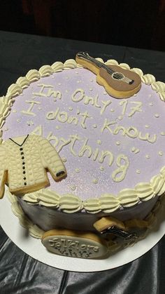 a birthday cake with an image of a sweater and a guitar