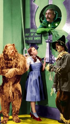 the wizard's costumed characters are standing in front of an advertisement for dr seuss