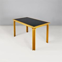 a wooden table with a black top and legs