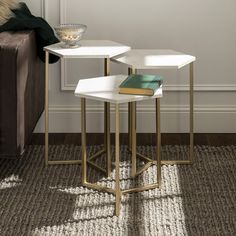 two tables with books on them in front of a couch