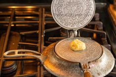 a frying pan with some food on it sitting on top of an oven burner