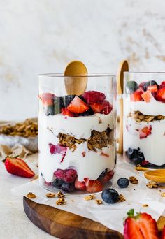 two glasses filled with yogurt and strawberries