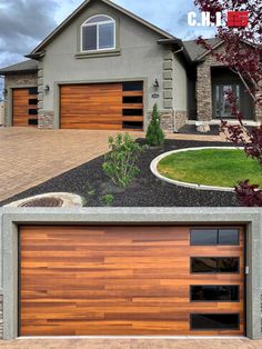 two garage doors in front of a house with landscaping around them and an attached driveway