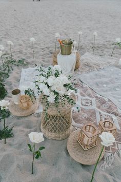 flowers and candles are placed on the beach