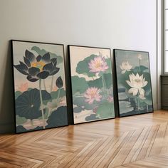 three framed paintings on the wall in an empty room with wood flooring and hard wood floors