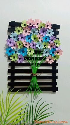 a bunch of flowers are placed on a wall