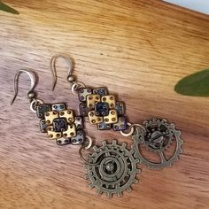 Hand Beaded Czech Steam Punk Earrings. For The Love Of Steam Punk.............Gold Qudra Tile Beads With Bronze Metal Miniature Gears. 3 1/2 Inches Long Hello, I Am Rita, A Master Beader I Have Kept My Work In The Family Until Now. Each Piece Is Carefully And Beautifully Hand Beaded. A Craft That Took Me Years Of Practice And Commitment. Every Piece Created Has Brought Me Joy While Bead Weaving. Found Object Jewelry, Hardware Jewelry, Punk Earrings, Vintage Bohemian Style, Statement Hoop Earrings, Bronze Metal, Steam Punk, Butterfly Earrings, Czech Beads