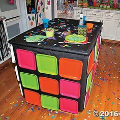 an image of a birthday party table in the middle of a room with confetti all over it