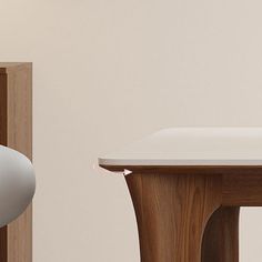 a computer mouse sitting on top of a wooden table next to a white desk and chair