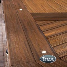 a close up of a wooden table with a sticker on the edge that says trex