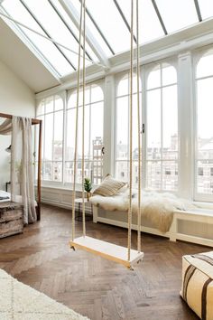 a bedroom with a swing bed and large windows