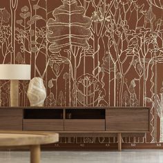 a living room with a wallpapered design and wooden table in the foreground