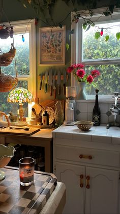 a kitchen filled with lots of clutter and cooking utensils on top of a counter