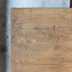 an old wooden table with peeling paint on the top and wood grains all over it