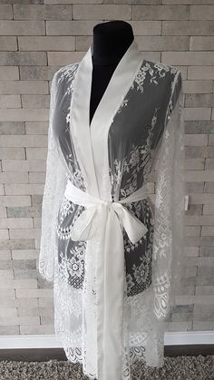 Off-white luxurious wedding robe, to add a perfect touch to your perfect and unique day. Only high quality fabrics and high finishing used for making the robe as neat as it can be. Please find the wedding robes collection here https://www.etsy.com/shop/LidiasBoutiqueDesign?ref=seller-platform-mcnav&section_id=25023222. For wedding dresses, please access https://www.etsy.com/shop/LidiasBoutiqueDesign?ref=seller-platform-mcnav§ion_id=23157290. For wedding tops and boleros, please access https: Elegant Lace Trim Sleepwear For Wedding Night, Feminine Lace Wedding Robe, Elegant Lace Trim Nightgown For Wedding Night, Elegant Wedding Nightgown With Lace Trim, Elegant Wedding Night Nightgown With Lace Trim, White Lace Nightgown For Wedding, Elegant Lace Bride's Robe, Elegant Lace Bridal Robe, White Lace Wedding Nightgown