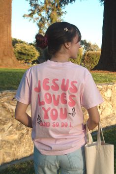 Show your love for Jesus and others with this beautifully designed Comfort Colors t-shirt! Made from 100% cotton, this high-quality tee is soft, comfortable, and perfect for everyday wear. The back of the shirt features the phrase "Jesus Loves You and So Do I" in a pretty pink font, serving as a heartfelt reminder that we are not only loved by Christ but are also called to love others as His followers. 🦋💕 The front of the shirt displays John 15:12, which reads: "This is my commandment, that you love one another as I have loved you." This scripture is a gentle encouragement to live out our faith daily and share Christ's love with those around us. Adorned with delicate butterflies symbolizing new beginnings in Jesus, this tee is ideal for anyone who wants to spread the Gospel message in a Rose Comfort, Shirt Displays, John 15 12, Pink Christian, Gifts For Young Women, Shirt Display, Gospel Message, Christian Friends, Christian Shirt