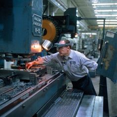 a man working on machinery in a factory