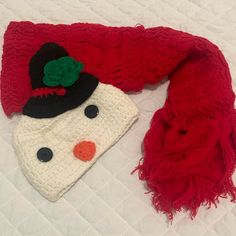 a red scarf with a snowman hat on it