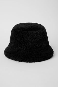 The iconic bucket hat just got a Sherpa update! Top off your cool-weather look with this plush Sherpa bucket hat, featuring a full, textured brim. Plush sherpa (faux fur) Center front woven patch Alo logo Wide Brim Black Bucket Hat For Winter, Casual Brimmed Hat With Plush Lining, Winter Black Flat Brim Bucket Hat, Black Flat Brim Bucket Hat For Winter, Black Hats With Plush Lining For Cold Weather, Black Brimmed Bucket Hat For Winter, Black Brimmed Hat With Fleece Lining, Sherpa Bucket Hat, Bucket Hat Black