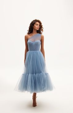 This light blue one-shoulder A-line midi dress features a puffy tulle skirt with a short underskirt, a lace-up corset bustier, and an asymmetrical sheer sleeve. Material: Tulle Composition: 100% polyester Skirt length from waist: 35.4 inches Dress weight: 17.6 lbs Neckline: Heart-shaped Back: Lace-up corset Built-in cups Lining: Light blue short underskirt Machine wash gentle cycle up to 86°F Do not bleach Steam up to 250°F Dry cleaning allowed Do not tumble dry Dry vertical Store hanging with i One Shoulder Tulle Cocktail Dress, One-shoulder Tulle Cocktail Dress, One-shoulder Tulle Gala Dress, Fitted One-shoulder Tulle Evening Dress, Elegant One-shoulder Fitted Tulle Dress, Elegant Fitted One Shoulder Tulle Dress, Elegant Fitted One-shoulder Tulle Dress, One Shoulder Tulle Skirt Dress For Wedding, Fitted Tulle Midi Dress For Bridesmaids