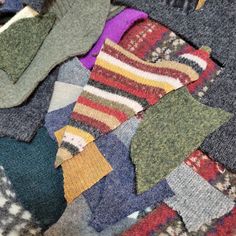 many different colored socks laying on top of each other