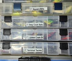 several plastic containers filled with different types of fishing lures and tackle hooks, along with labels on them