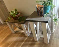 two tables with plants on them in front of a window and a planter next to the table