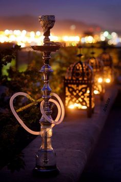 a couple of candles sitting on top of a metal pole