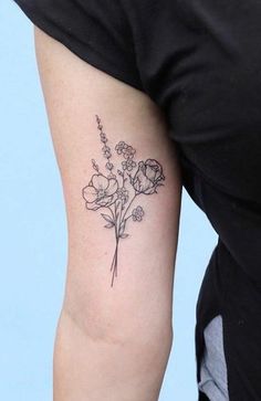 a woman with a flower tattoo on her arm