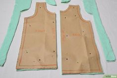 two pieces of paper are cut out to make a vest for a child's dress