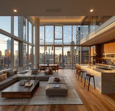 a living room filled with lots of furniture and large windows overlooking the cityscape