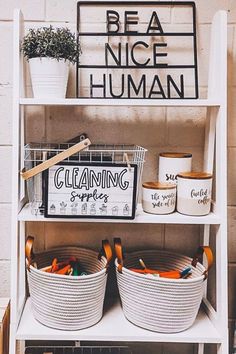 a shelf filled with baskets and buckets next to a sign