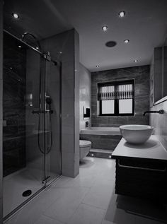 a black and white photo of a modern bathroom