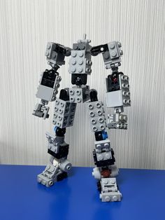 a robot made out of legos on a blue surface