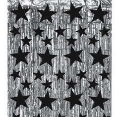 a black and white photo with stars on the wall in front of a curtain that has tin foil over it