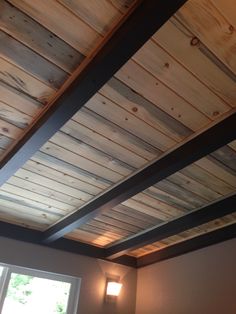 the ceiling in this bedroom is made from wood planks