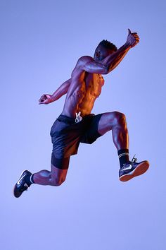 a shirtless man is jumping in the air