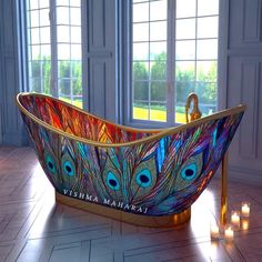 a bathtub with peacock feathers painted on it and candles in front of the tub