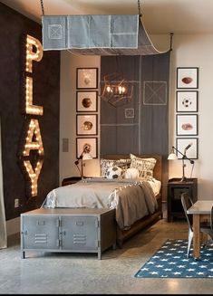 a bed room with a neatly made bed next to a night stand and lights on the wall