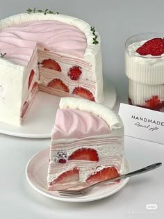 a piece of strawberry cake on a plate with a fork next to it and a jar of strawberries in the background