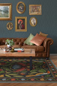 a living room filled with furniture and pictures on the wall above it's coffee table