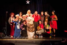 a group of people standing on top of a stage