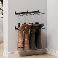 four pairs of boots are hanging on the wall