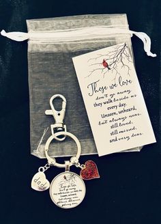 a keychain with a poem on it next to a bag and a card