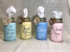 four painted mason jars with tissue paper in them