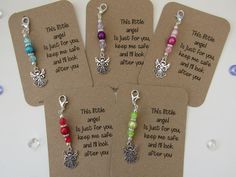 four tags with different colored beads on them