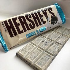 hershey's cookies and cream bar sitting on top of a counter next to it